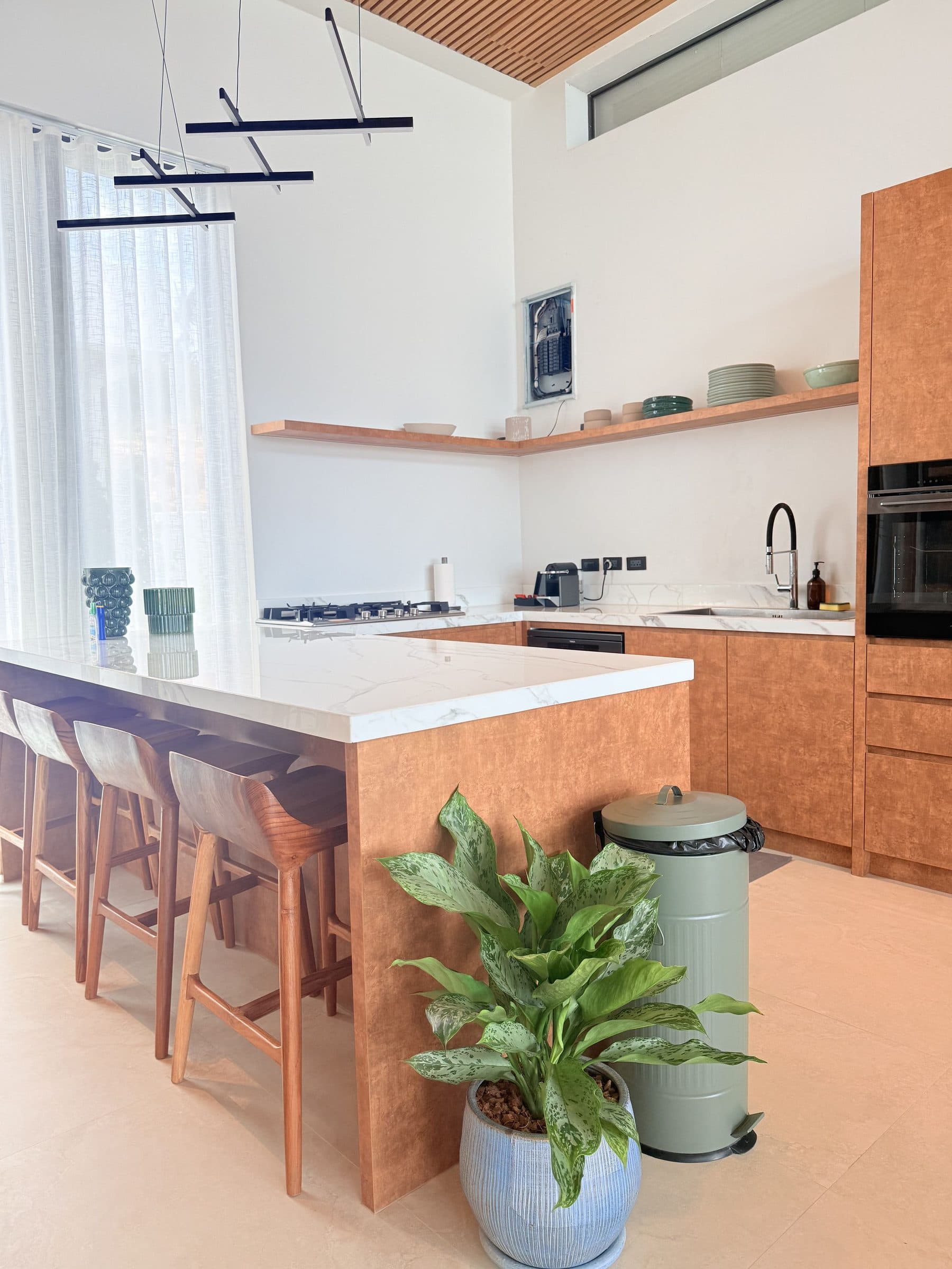 Kitchen island with marble counter and timber cabinetry