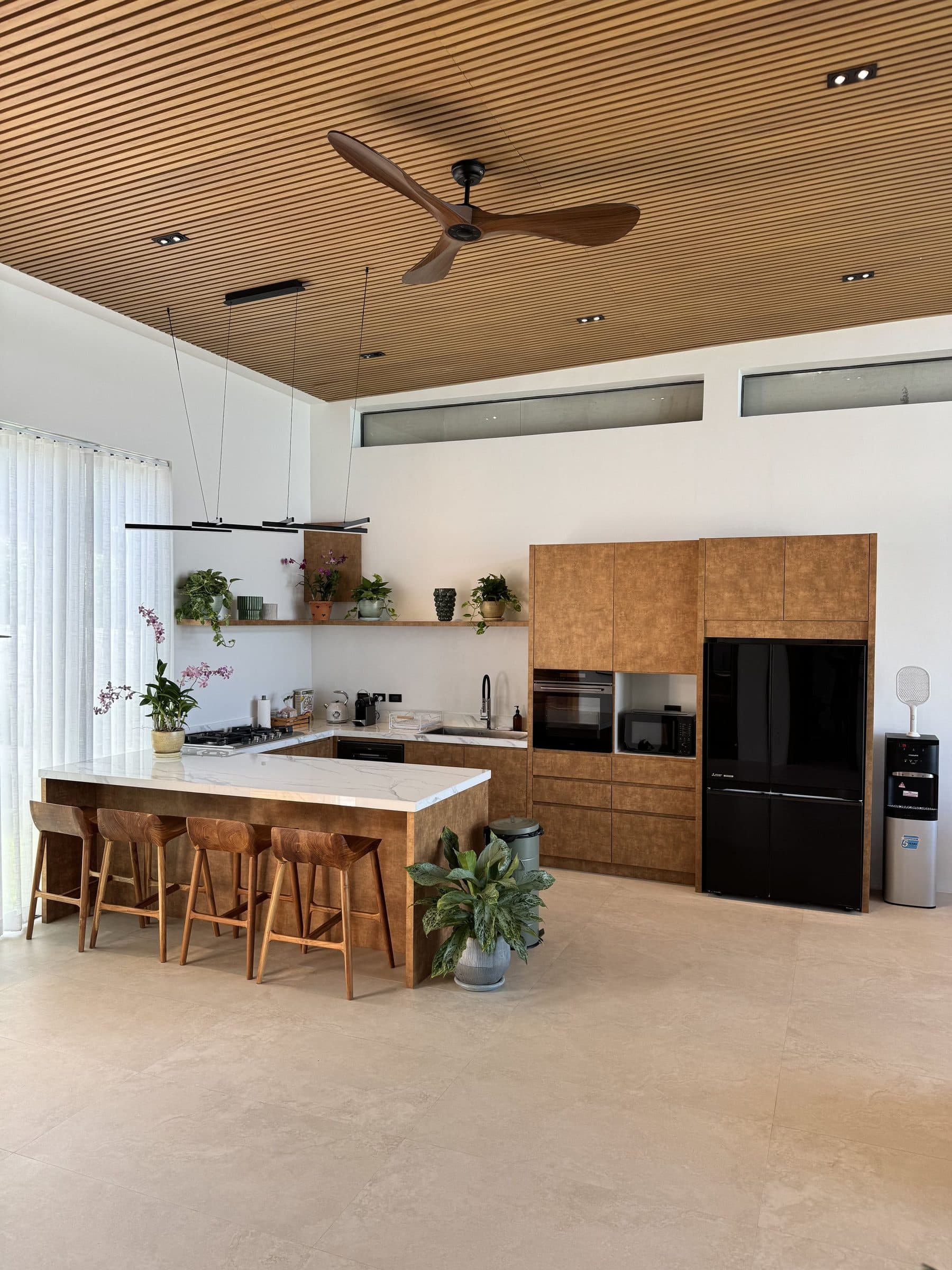 Full kitchen with island and bar stools